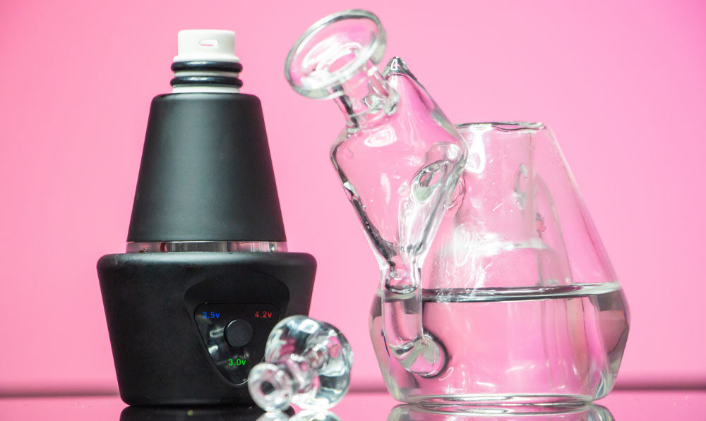 Sutra DBR Pro standing on reflective surface in front of pink studio background with water in bubbler