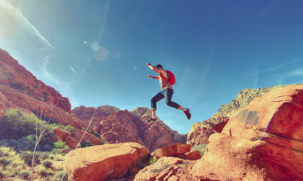 Man jumping between rocks