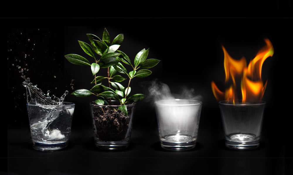 Water, earth, air and fire resting in their own glasses on a black display
