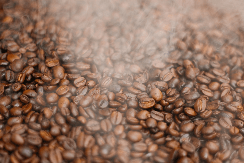 Freshly roasted coffee beans with steam