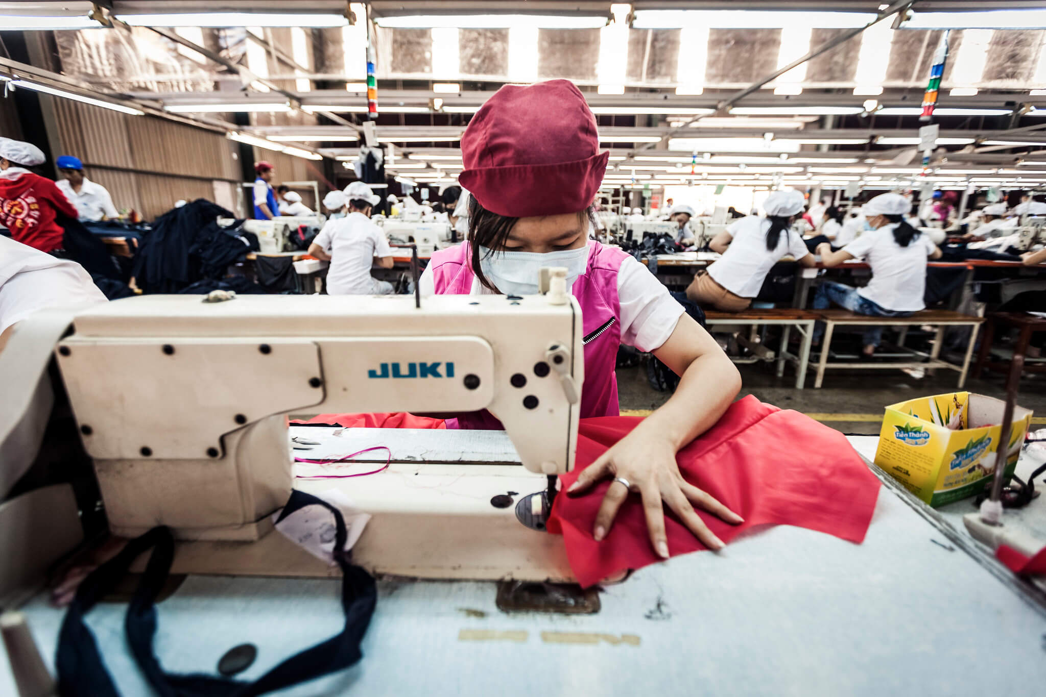 recycled polyester being sewn in China into garments
