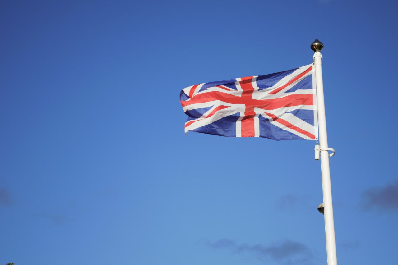 UK flag on white flag pole