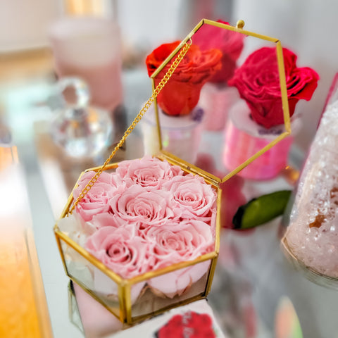 pink roses in a glass case