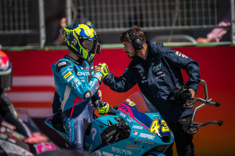 Xavier Artigas shaking hands with crew after race at Circuit of the Americas. Artigas finished in third place.