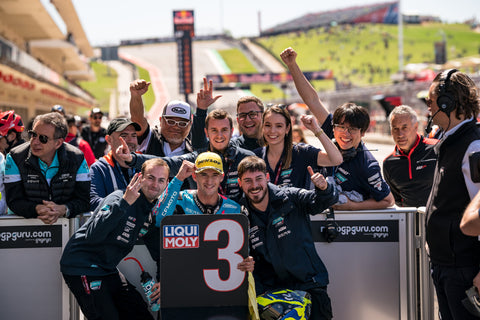 Xavier Artigas holds up third-place finish sign at Circuit of the Americas.