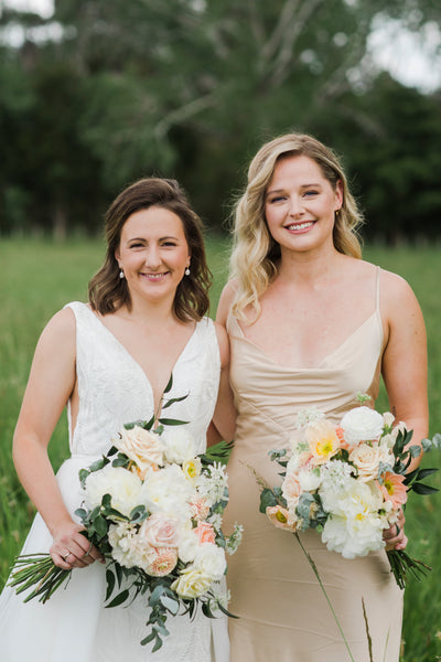 bride and her bridesmaids holding fresh bouquets