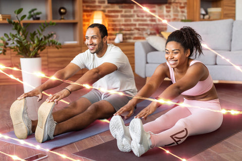 couple exercising in living room displaying good workout habits