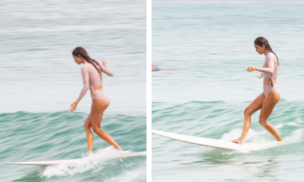 GIRL IN A PINK OUTFIT PINK SURFBOARD SURFING NOOSA