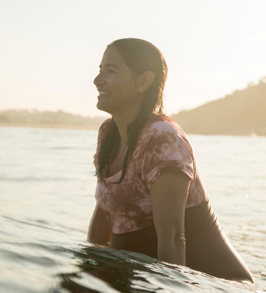 Pregnant surfer smiling in the Socoa Surfsuit