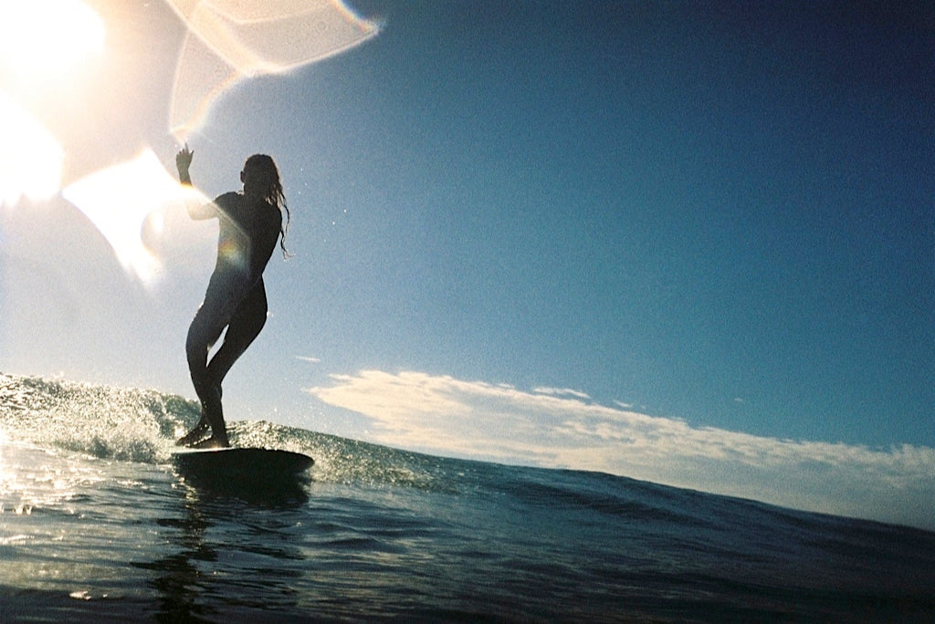 Shadow light film photo of a woman surfer