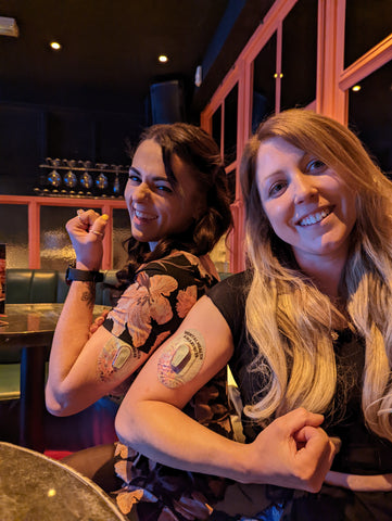 Two girls with type one diabetes wearing their protective patches for their Dexcoms, enjoying a night out