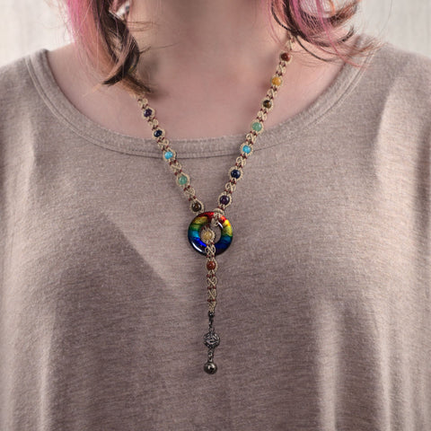 Young woman wearing a custom macramé chakra themed lariat