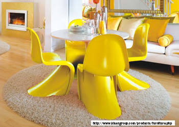 A photo of a Panton chair, which is a modernist chair with a fluid and sculptural form, designed by Verner Panton in the 1960s. The chair may have a monochrome or multicolor finish and it is made of molded plastic or fiberglass. The photo may show the chair in a variety of settings, such as a dining room, lounge, or office. 