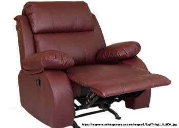 A photo of a recliner chair, which features a comfortable and adjustable backrest and footrest. The chair may be upholstered in leather or fabric and may have additional features like massage, heating, or built-in cup holders. The photo may show the chair in a living room or home theater setting, with a person sitting or reclining in it.