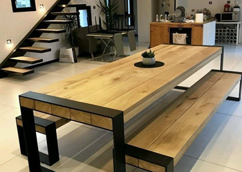 A photo of a piece of furniture that combines wood and metal or steel materials. The photo may show a dining table, desk, or shelving unit, with a wooden tabletop or shelves and metal or steel legs or frame. 
