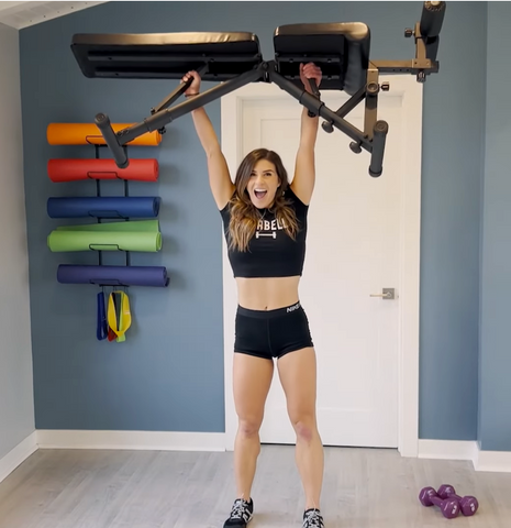 A Woman Holding The Nordic Weight Bench