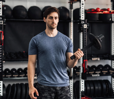 A Man Holding The Torque Bar By Tib Bar Guy | ATG Workout