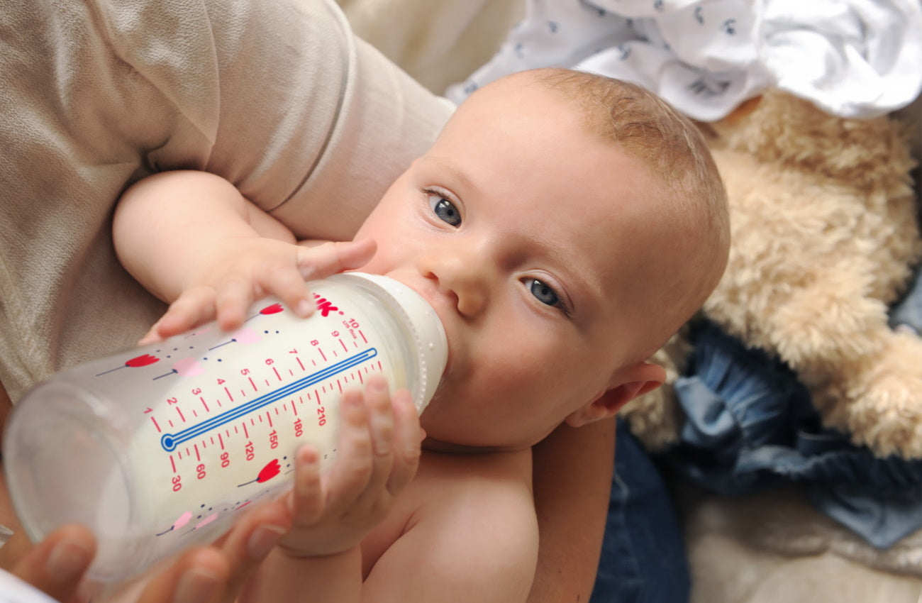 Baby feeding from a bottle. NUK. Belly Beyond NZ.