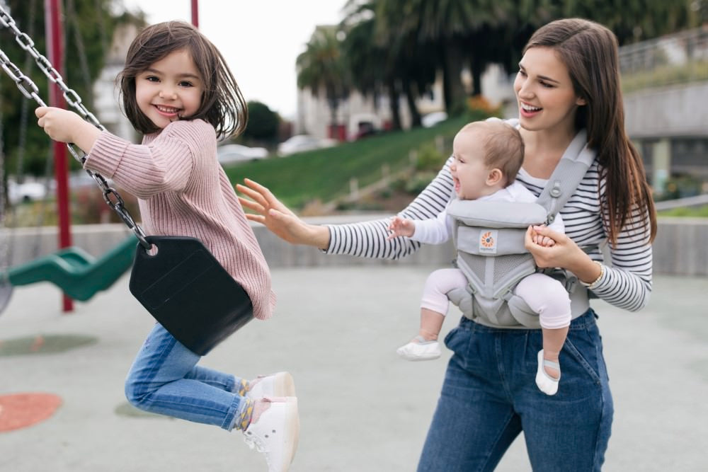 Mum baby and sibling all staying active with the help of Ergobaby's Omni 360 Carrier Cool Air Mesh.