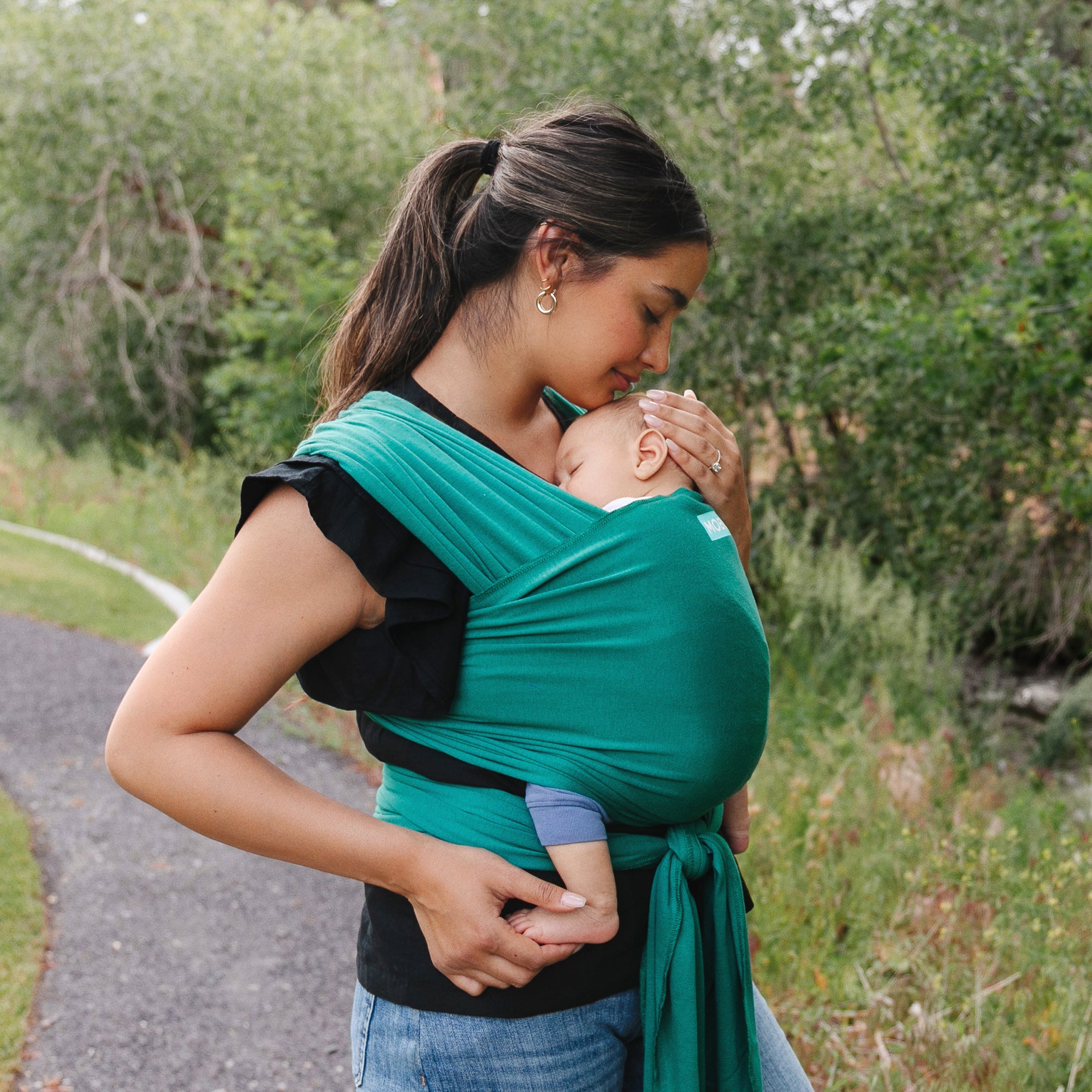 Mum and baby in the Evolution Baby Wrap by MOBY. Baby's soft C-shape curve is supported by the wrap. Belly Beyond NZ.
