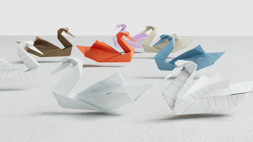 Variety of paper swans floating in space 
