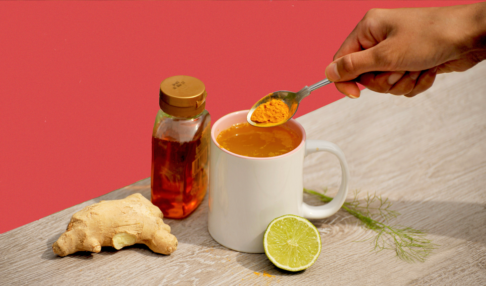 spoon of turmeric with honey, ginger and lemon