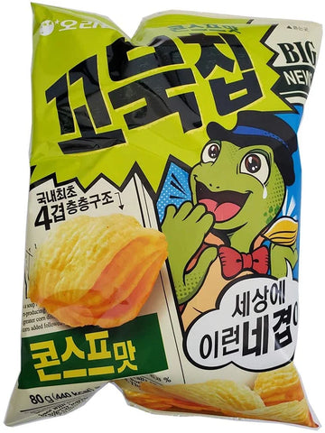 A bright green bag of snacks featuring a cartoon turtle character. The text is primarily in Korean, but "BIG NEW" is visible in English. Turtle Chips Korean Snack