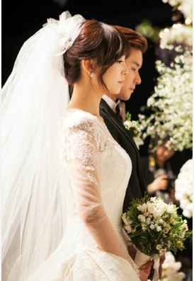 Sunye standing beside James Park at wedding