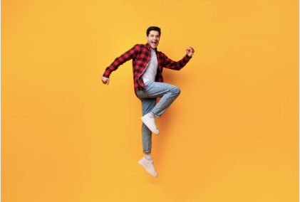 A man dancing on a yellow background