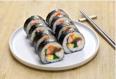 Kimbap on a plate beside chopsticks