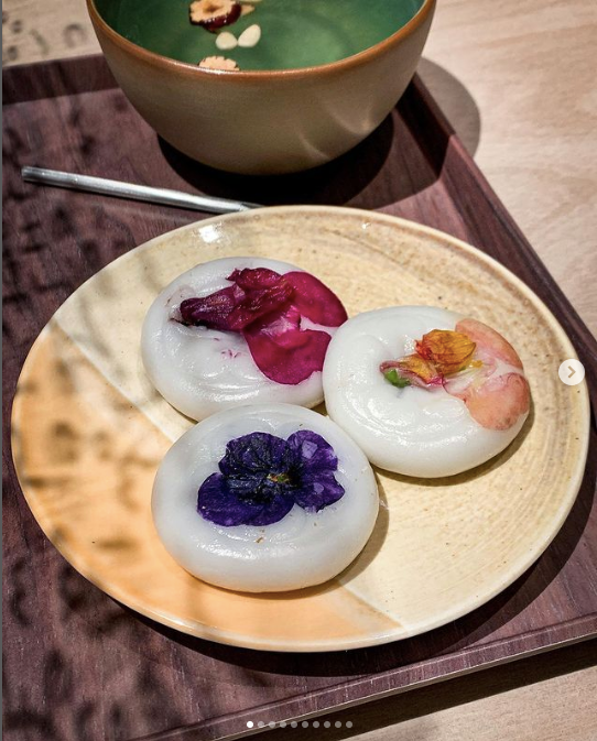 Three hwajeon on a plate next to punch bowl