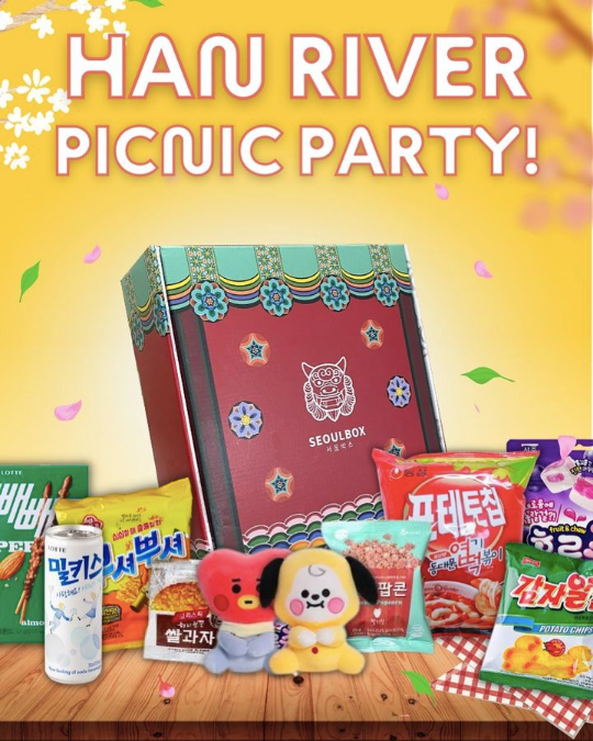Red box with snacks and merch on a yellow spring background