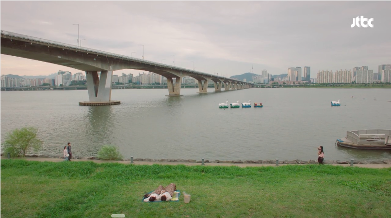 A couple lying on the grass overlooking the Han River