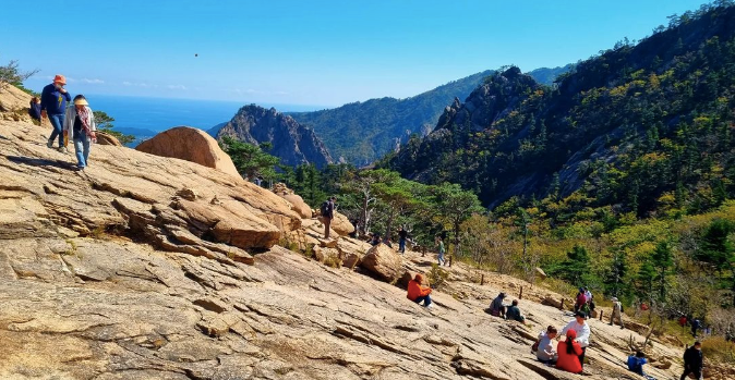 Hikers taking a break on a mountaintop in Seoraksan National Park