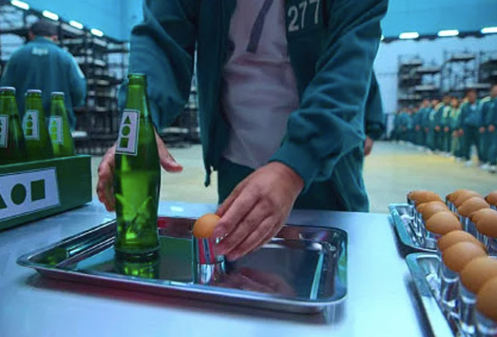 A man loading a tray with Sprite bottle and hard-boiled egg