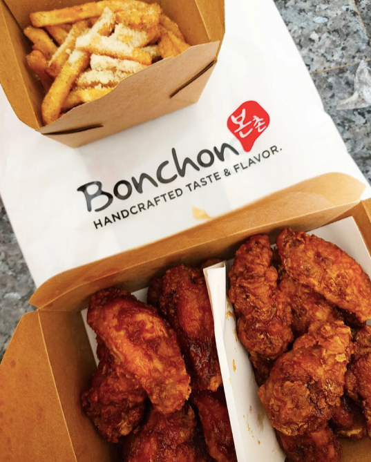 Chicken and fries in takeout boxes with Bonchon logo