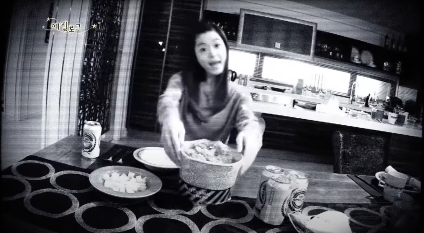 Security cam footage of woman setting down bucket of fried chicken