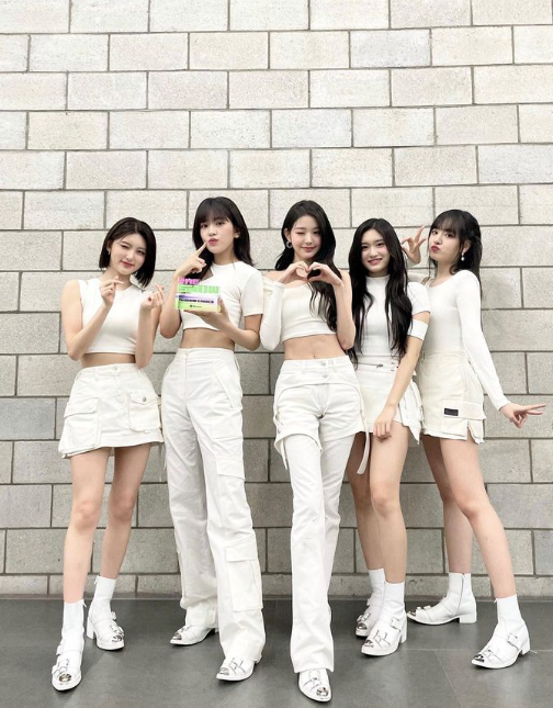 Five girls dressed in white holding awards