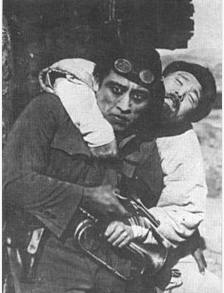 A mountain climber carrying another man on his back