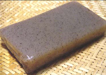 Thin slab of gray konyakku on tatami mat