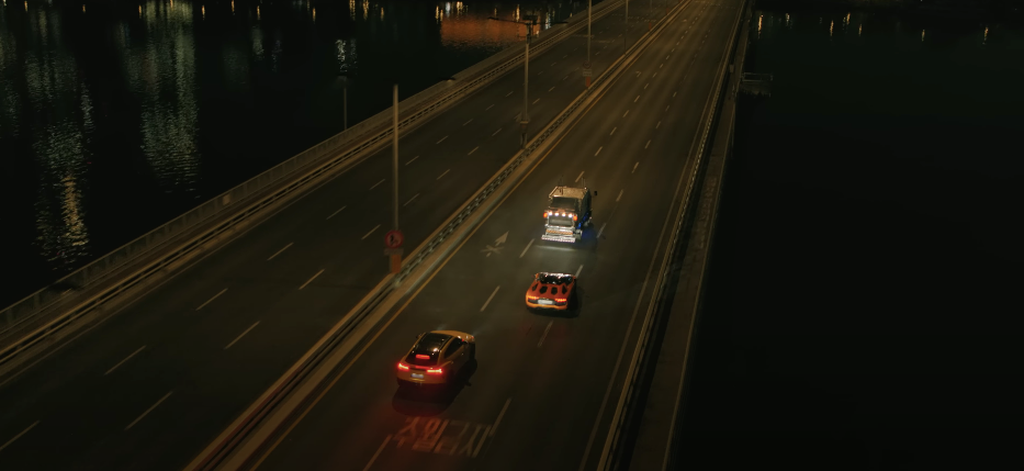 Three cars on a highway at night