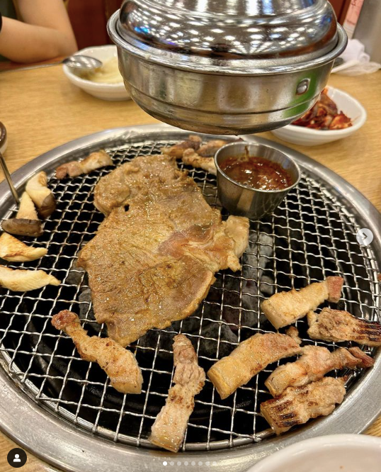 Pieces of Jeju Island black pork on a grill with gochujang