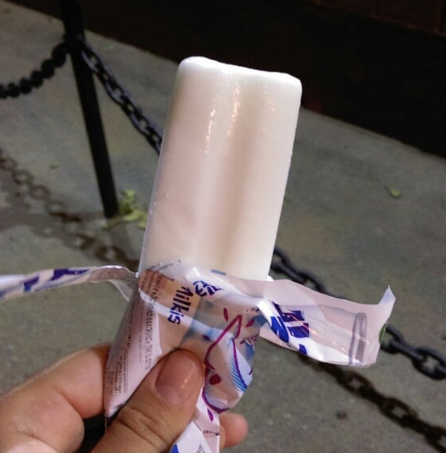 A hand holding a Milkis-flavored ice cream stick