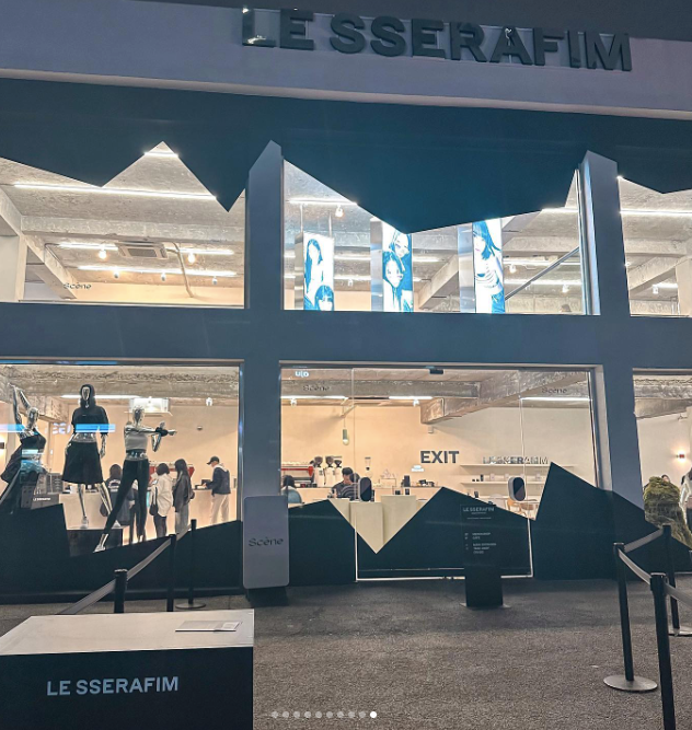 Exterior of LE SSERAFIM pop-up store with mannequins visible inside