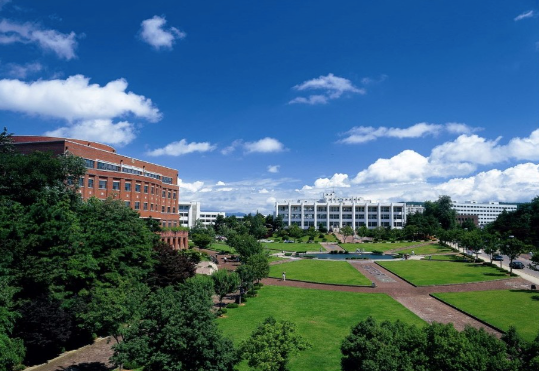 Red brick building on CNU campus with trees and green fields