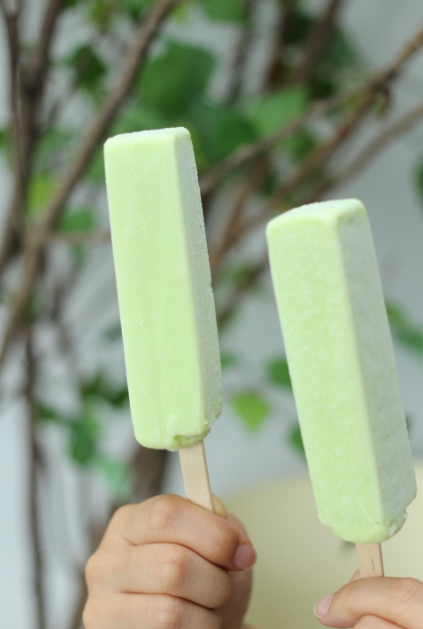 Two hands holding green Melona bars