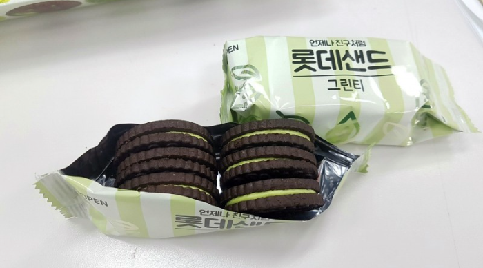 An opened bag of green tea sandwich cookies with unopened bag behind it