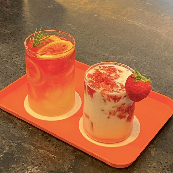 An orange-based ade and a strawberry cream iced drink