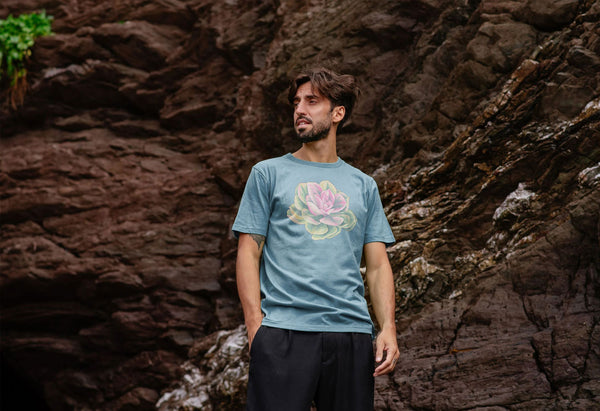 man on a beach with blue t-shirt with a colourful echeveria succulent plant on it