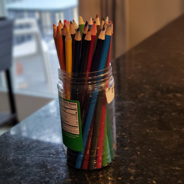 Image showing how to use an empty ginger paste container to organize and hold color pencils.